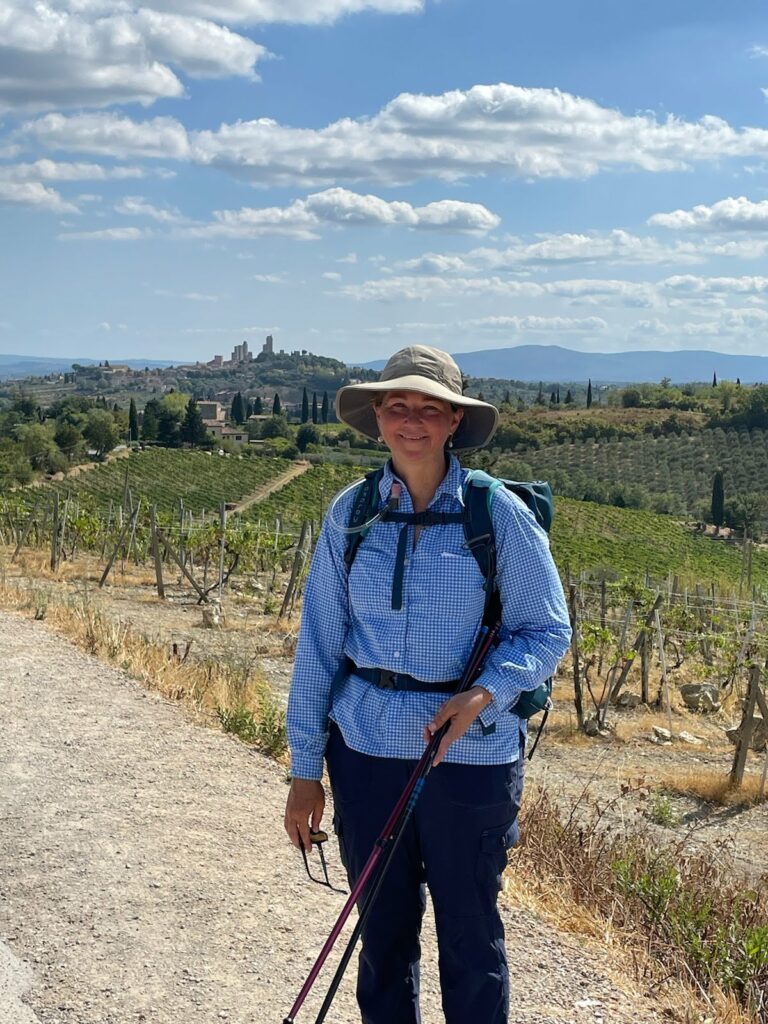 Woman, female, on a walking trail, mountains and towers.