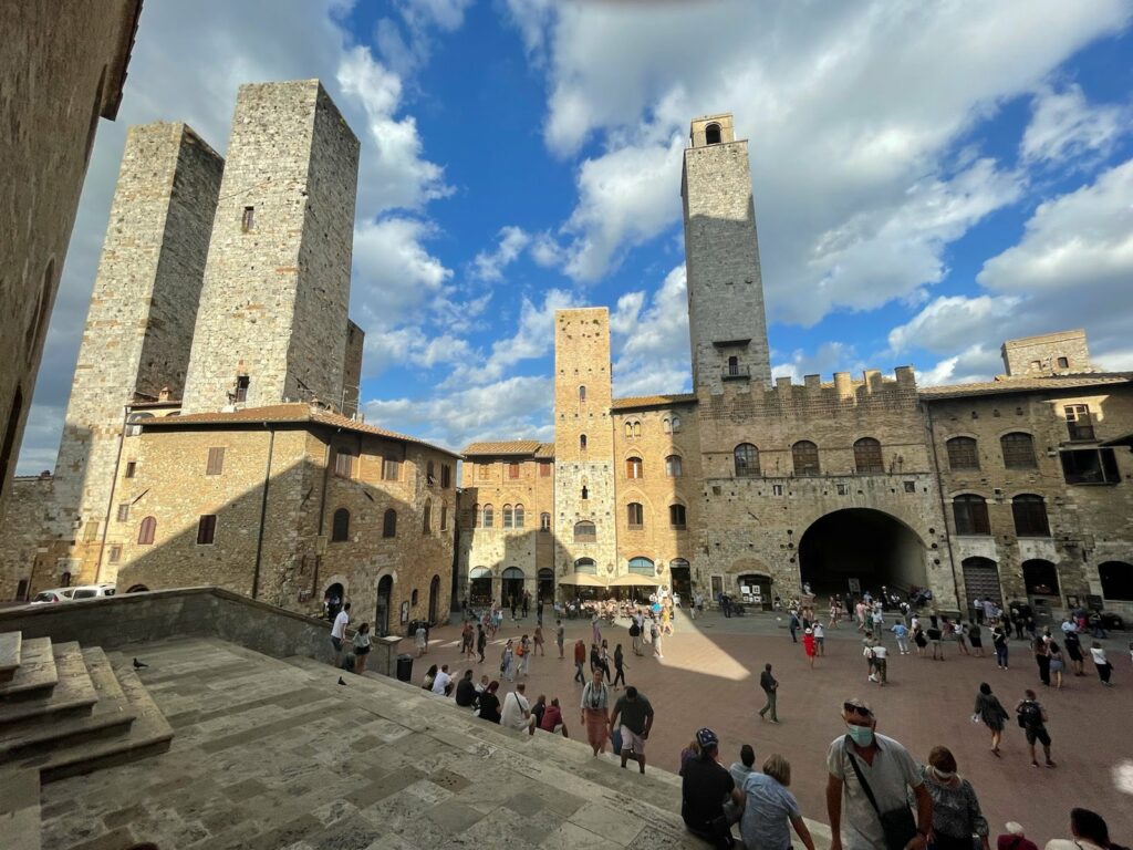 Buildings, people, blue sky with clouds, San Gimigniano